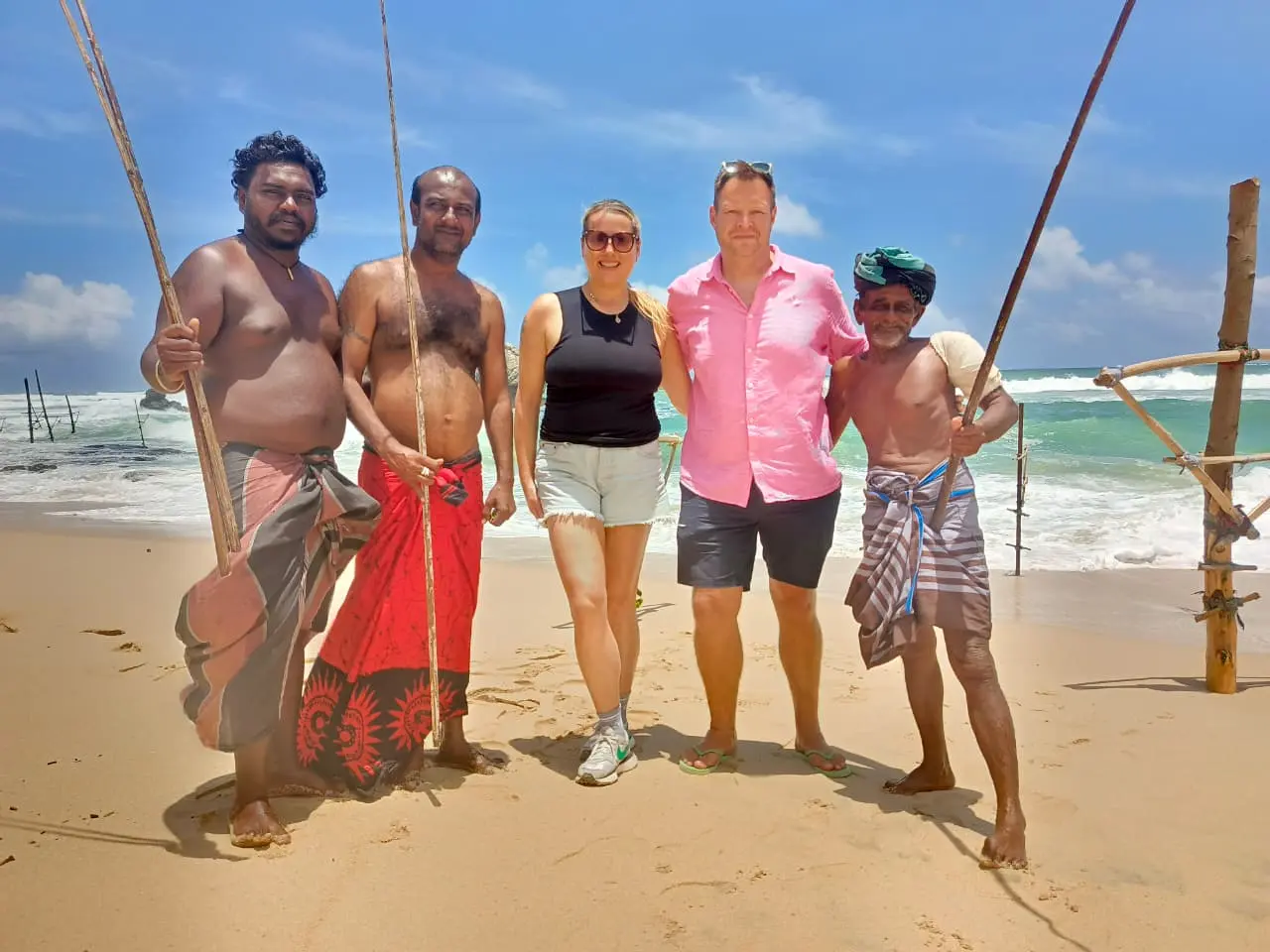 Travelers exploring the golden sands of Mirissa and meeting friendly local fishermen